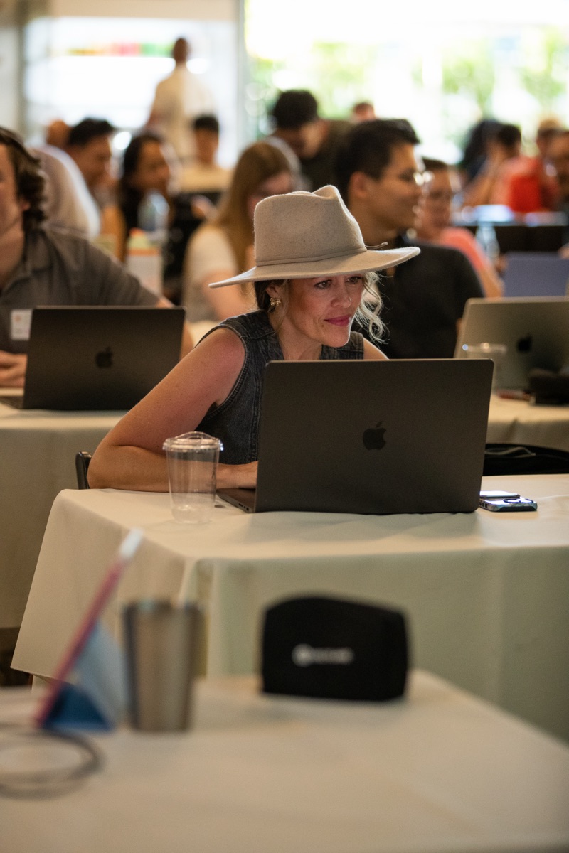 Packed room — laptops open, ready to build