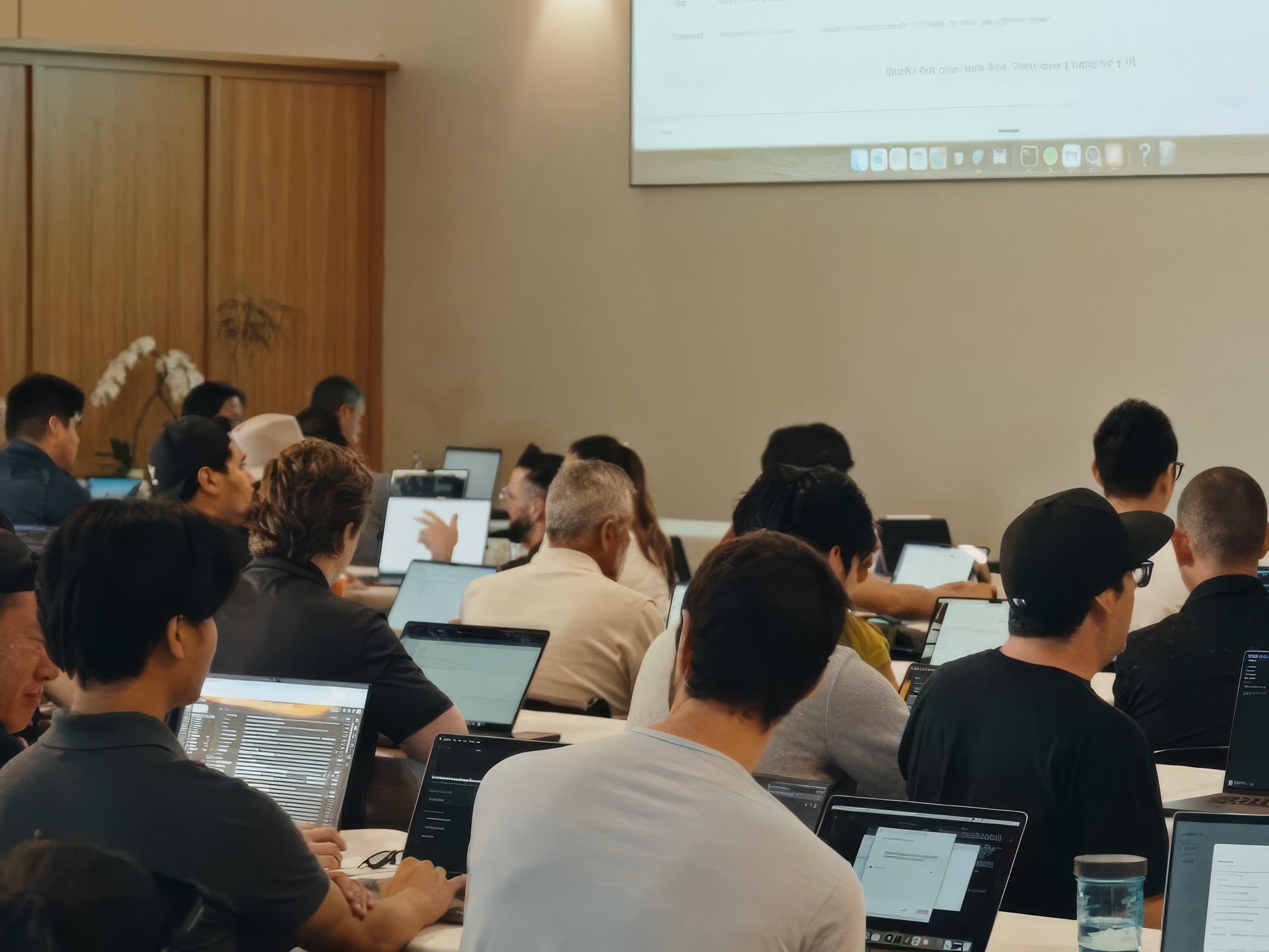 Attendees working on laptops during a hands-on building session